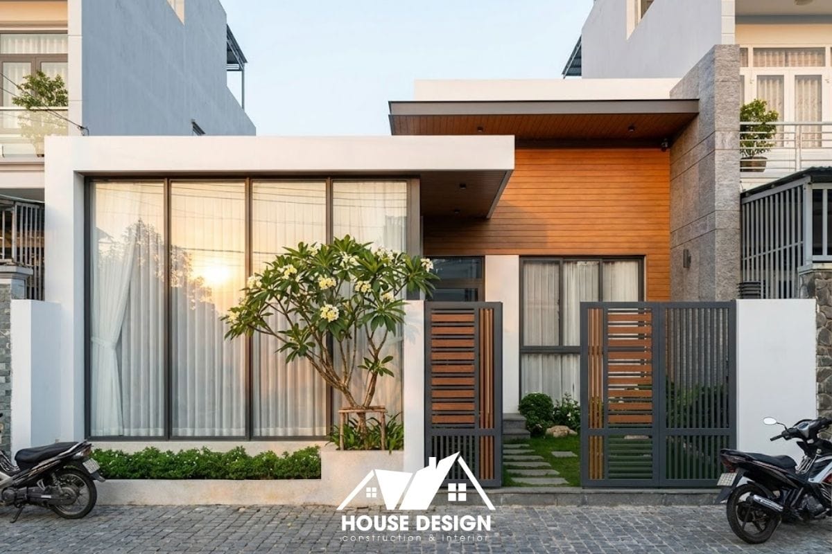 Mặt tiền nhà cấp 4 ngang 6m cải tạo theo phong cách hiện đại với cửa kính lớn và mảng tường ốp đá tự nhiên.