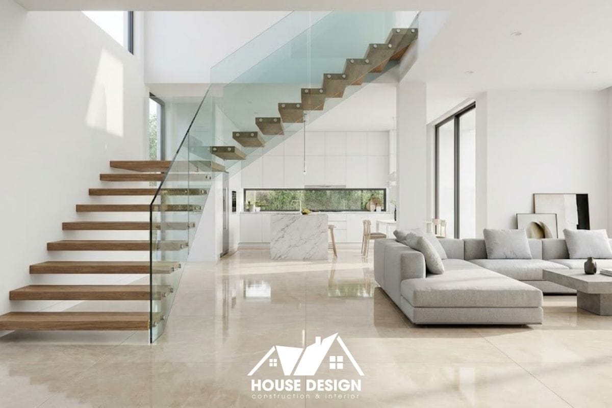 Không gian phòng khách hiện đại với điểm nhấn là hệ cầu thang lan can kính giúp tầm nhìn xuyên suốt và rộng rãi.